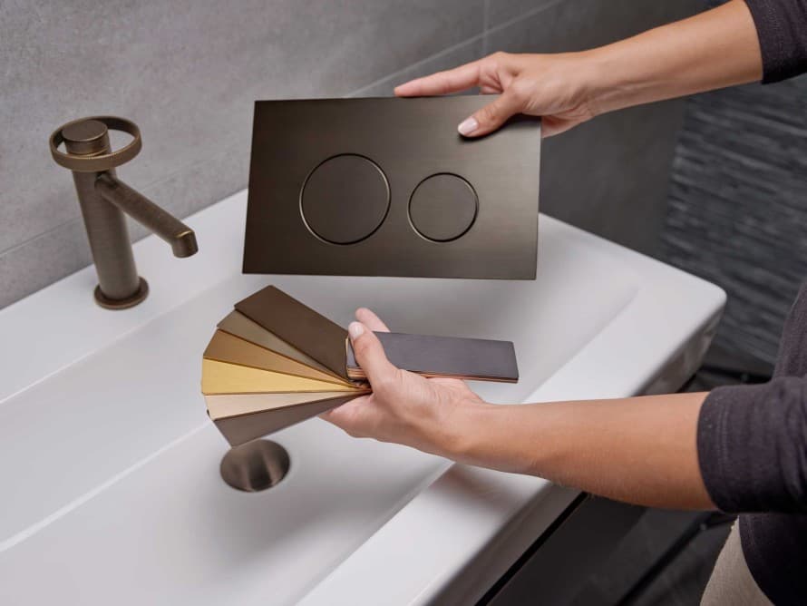 Geberit Sigma40 tilpasset servantarmatur i bronsefinish.