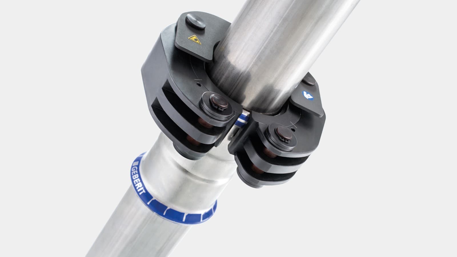 Klikkmekanismen fester Geberit press-slingene på Geberit Mapress fittingen Klikkmekanismen fester Geberit press-slingene på Geberit Mapress fittingen